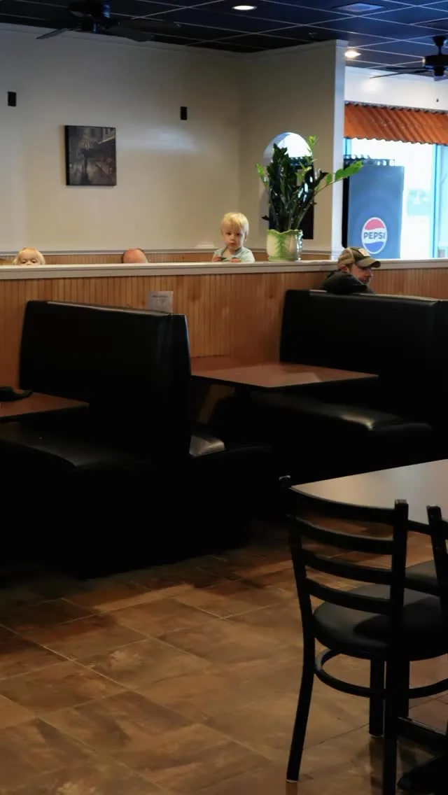 Guests seated in the booths of the Bellini dining room